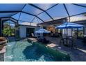 Relaxing screened-in pool area with outdoor seating and dining space at 15691 Meacham Cir, Port Charlotte, FL 33981