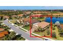 An aerial view of the house with a tile roof, beautiful pond and surrounded by a cozy neighborhood at 209 Malina Ct, Nokomis, FL 34275