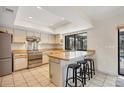 Bright kitchen with a breakfast bar, stainless steel appliances, and ample counter space at 3892 Alwood St, North Port, FL 34291
