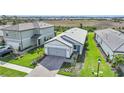 Aerial view of a single-story home with paved driveway and well-manicured lawn at 6237 Fish Eagle Ct, Nokomis, FL 34275