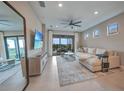 Spacious living room featuring tile floors, a ceiling fan, and sliding glass doors at 6237 Fish Eagle Ct, Nokomis, FL 34275