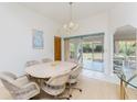 Bright dining room adjacent to the screened lanai; perfect for everyday meals and entertaining guests at 11453 Oceanspray Blvd, Englewood, FL 34224