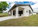 This single-story home features a covered porch with brick supports and a well-kept lawn at 13360 Foresman Blvd, Port Charlotte, FL 33981