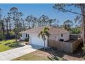 Well-maintained single Gathering home, featuring an attached garage and partially fenced yard at 14795 San Domingo Blvd, Port Charlotte, FL 33981