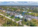 Gorgeous aerial view of waterfront homes, canals, boat docks and lush landscaping in a neighborhood at 15776 Melport Cir, Port Charlotte, FL 33981