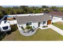 Charming single-story home with well-manicured lawn, RV parking, above ground pool and white privacy fence at 18970 Mcgrath Cir, Port Charlotte, FL 33948