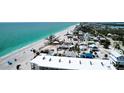 Expansive aerial view featuring beachfront homes nestled along the pristine shoreline, enhanced by clear blue waters at 40 Sand Dollar Ln, Englewood, FL 34223