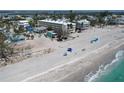 Breathtaking view of pristine beach with clear waters and white sand near a residential area at 40 Sand Dollar Ln, Englewood, FL 34223