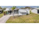 Inviting single-story home featuring a covered carport and well-manicured lawn at 8436 Buttonquail Dr, Englewood, FL 34224
