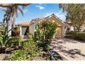 Attractive home with a terracotta roof, well-maintained landscaping, and a brick driveway at 10508 Crooked Creek Dr, Venice, FL 34293