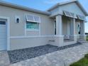 Charming home exterior featuring stone accents, modern windows, and well-maintained landscaping at 10688 Mcalester Cir, Port Charlotte, FL 33981