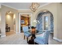 Charming foyer featuring a glass table, blue wallpaper, and archways leading to other rooms at 10953 Bullrush Dr, Venice, FL 34293