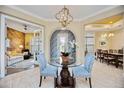 Elegant foyer with a glass table, arched doorway, and views of the living and dining areas at 10953 Bullrush Dr, Venice, FL 34293