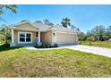 Attractive single-Gathering home with a two-car garage, well-maintained lawn, and appealing curb appeal at 1183 Cedar Ave, Englewood, FL 34223