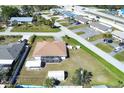 A birds eye view of a private home featuring an enclosed lanai, a shed, and a generous yard at 1317 Le Pera Rd, Englewood, FL 34223