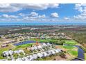 Expansive aerial view of a golf course community showcasing lovely homes, scenic waterways, and lush landscaping at 16 Windward Ter, Placida, FL 33946