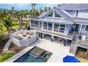 Beautiful elevated deck and private pool with spa feature inviting outdoor living and entertaining at 16250 Sunset Pines Cir, Boca Grande, FL 33921