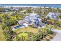 Coastal home with private pool, putting green, and beach access, surrounded by tropical landscaping at 16250 Sunset Pines Cir, Boca Grande, FL 33921