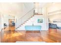Bright foyer with hardwood floors, modern staircase, and stylish decor at 16250 Sunset Pines Cir, Boca Grande, FL 33921