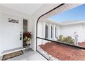 Inviting front porch with decorative statue, flower pot, and a tiled floor at 184 Eppinger Dr, Port Charlotte, FL 33953