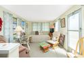 Cozy living space filled with natural light from the large windows and complete with comfortable furnishings at 3210 Holly Ave, Englewood, FL 34224