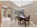 Cozy dining area with a pool view, modern chandelier, and access to the living spaces at 4050 Rock Creek Dr, Port Charlotte, FL 33948