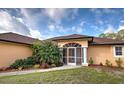 Inviting front entrance with a screened porch, manicured landscaping, and a well-maintained walkway at 4966 Sunnyvale Rd, North Port, FL 34288