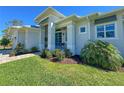 Charming single-story home featuring a beautifully landscaped front yard and a welcoming glass-door entrance at 5 Reef Ct, Placida, FL 33946