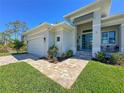 Well maintained home showing the front entrance with a brick pathway and an attached garage at 5 Reef Ct, Placida, FL 33946