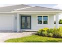 The house features a front entrance with attractive double doors and neat, well-maintained landscaping at 5213 Willow Lake Ct, Sarasota, FL 34233