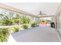 Spacious screened-in patio featuring a ceiling fan and ample space for outdoor seating and entertaining at 5441 Farley St, Port Charlotte, FL 33981