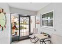 Cozy screened-in porch featuring tile flooring and outdoor seating at 613 Chestnut Ln, Englewood, FL 34223