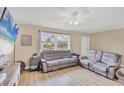 Spacious living room featuring a large window, modern flooring, neutral walls and comfortable seating at 6264 Drucker Cir, Port Charlotte, FL 33981