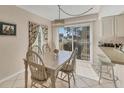 Dining area featuring a table with six chairs, pendant lighting, and sliding glass doors to the exterior at 6699 San Casa Dr # Q3, Englewood, FL 34224