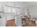 Bright kitchen boasts white cabinetry, marble countertops, stainless steel appliances, and breakfast bar seating at 7430 Palm Island Dr # 3813, Placida, FL 33946
