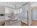 Updated kitchen with white cabinets, marble countertops, stainless appliances and hardwood floors at 7430 Palm Island Dr # 3813, Placida, FL 33946