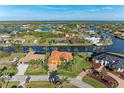 Gorgeous waterfront property with a terracotta roof, lush landscaping, and canal access to the ocean at 8264 Antwerp Cir, Port Charlotte, FL 33981