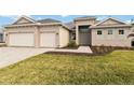 Charming single story home with a three-car garage, stone driveway, and mature landscaping at 8562 Shore Lake Dr, Englewood, FL 34224