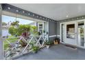 Inviting front porch adorned with potted plants and hanging lights, leading to the home's entrance at 9341 Oceanspray Blvd, Englewood, FL 34224