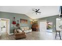 Spacious living room with vaulted ceilings, wood floors, and ample natural light at 9341 Oceanspray Blvd, Englewood, FL 34224