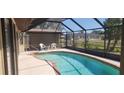 Enclosed pool with clear blue water offering privacy and comfort at 95 Mark Twain Ln, Rotonda West, FL 33947