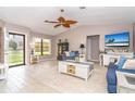 Inviting living room with vaulted ceilings, wood-look tile flooring, and comfortable seating arrangements at 10075 Bentley Ave, Englewood, FL 34224