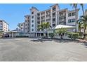 Condominium complex featuring multi-story buildings, ample parking, and lush landscaping at 13313 Gasparilla Rd # 404, Placida, FL 33946