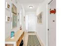 Bright entryway with tile flooring, white walls, and decorative coastal-themed accents at 13313 Gasparilla Rd # 404, Placida, FL 33946