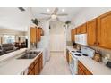 Functional kitchen featuring wooden cabinets and essential appliances at 1332 Hedgewood Cir, North Port, FL 34288