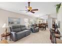 Bright living room featuring tile flooring, ceiling fan, and comfortable seating at 1332 Hedgewood Cir, North Port, FL 34288