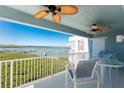 Relaxing balcony seating area with ceiling fans and stunning water views offers a tranquil escape at 1410 Beach Rd # 201, Englewood, FL 34223