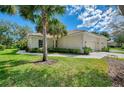 Beautiful single-Gathering home with lush landscaping, a well-maintained lawn, and an attached garage at 14298 Reserve Ct, Port Charlotte, FL 33953