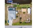 Expansive property featuring a pool, dock, and multiple outdoor structures, offering a luxurious waterfront lifestyle at 14382 Lillian Cir, Port Charlotte, FL 33981