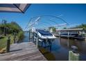 A private boat dock with a boat lift provides convenient access to waterways for boating and water activities at 14382 Lillian Cir, Port Charlotte, FL 33981